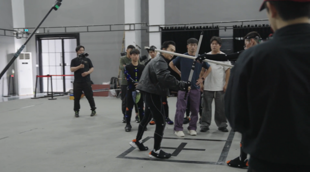 Actor Donnie Yen practices swordplay choreography with other actors at S-Game's Shanghai motion capture studio.
